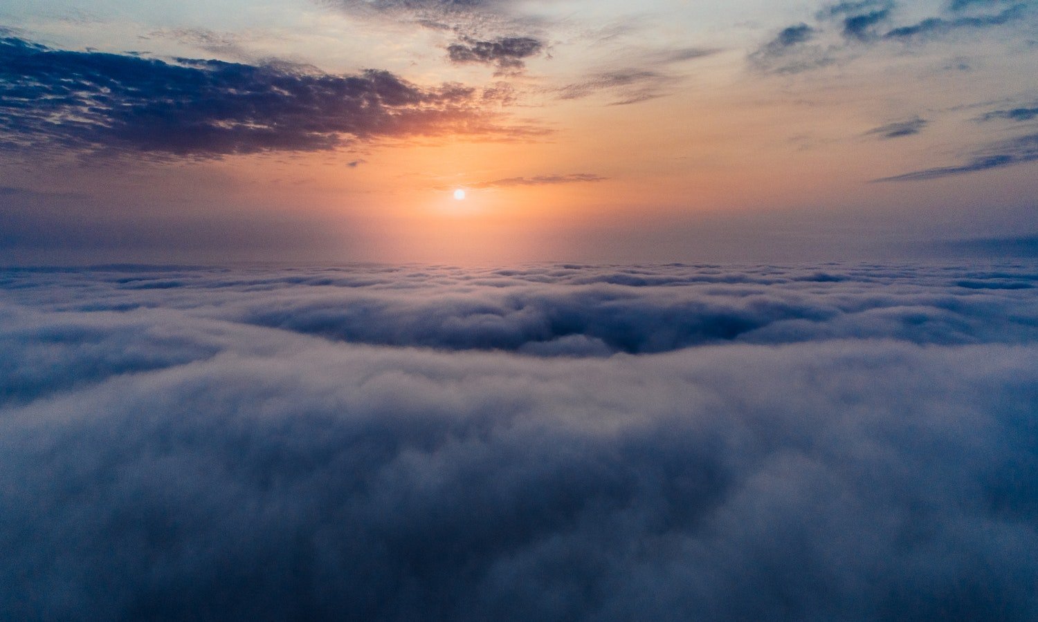 sun shines above clouds