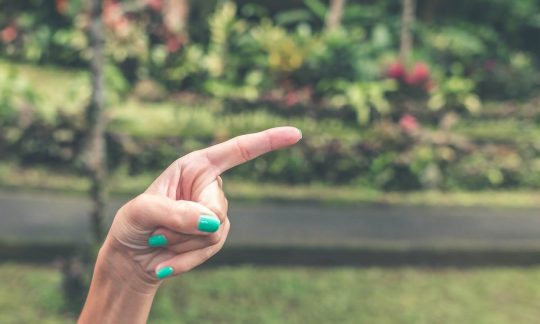 pointing-hand-of-a-white-woman