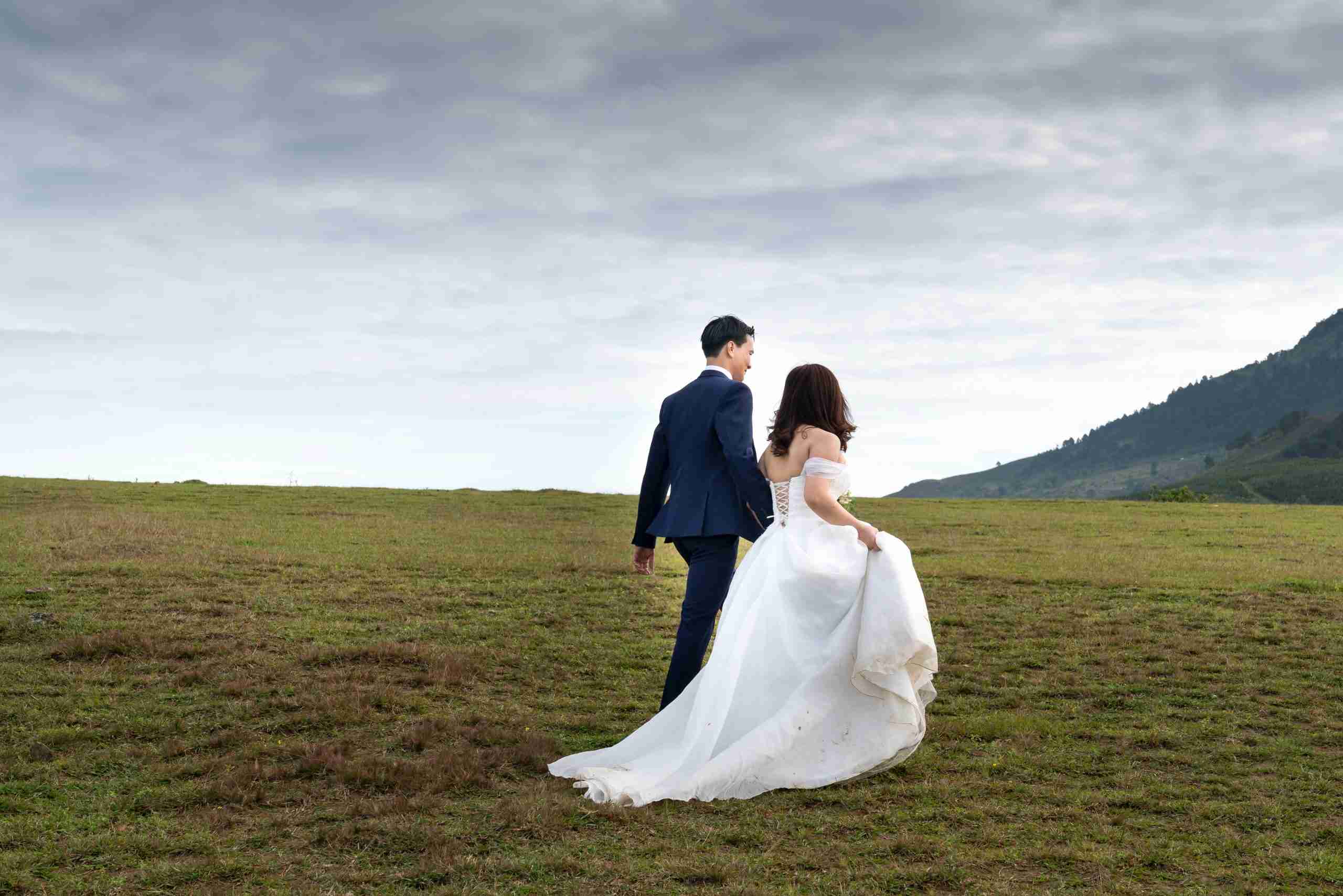 interracial-couple-bride-groom-walking-in-their-wedding-outfits