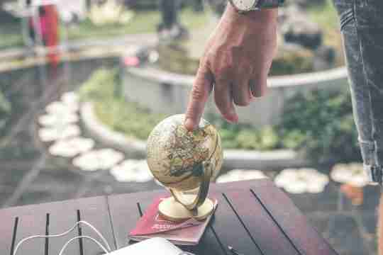 person-holding-terrestrial-globe-scale-model
