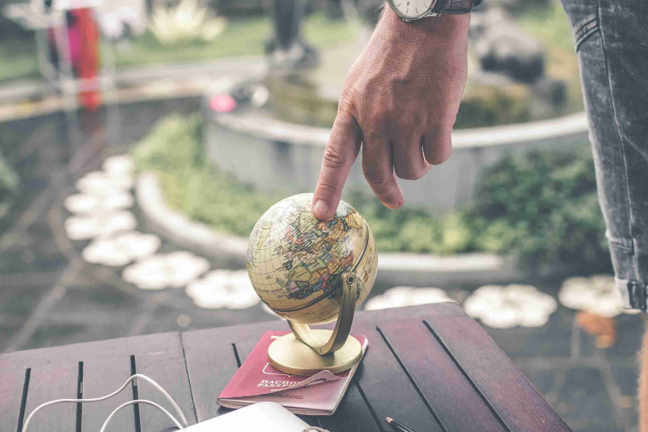 person-holding-terrestrial-globe-scale-model