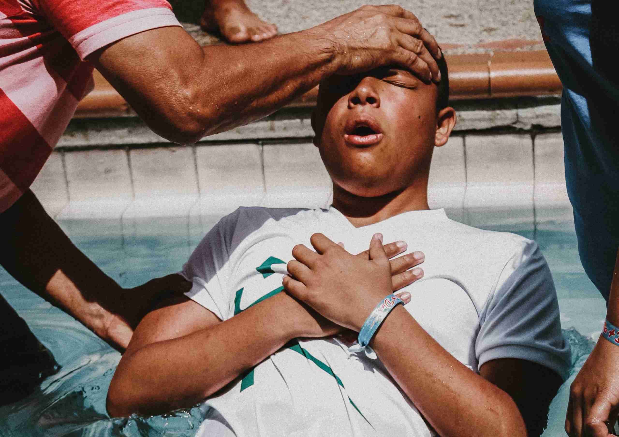 a-man-doing-christian-baptism-on-the-water