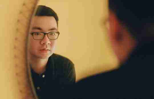 photo-of-man-looking-at-the-mirror