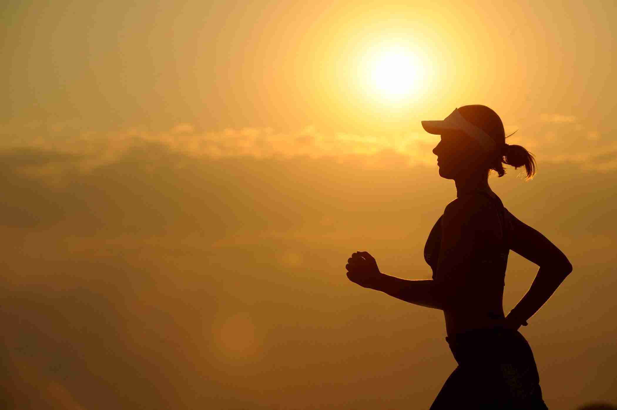 woman-with-white-sunvisor-running