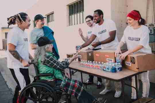 man-in-white-crew-neck-t-shirt-sitting-on-black-wheelchair