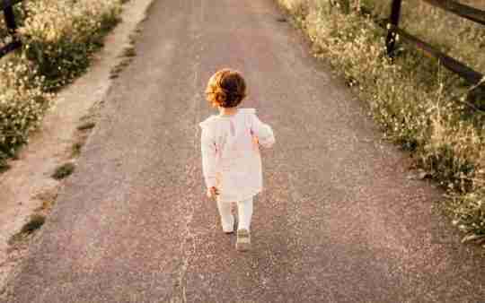 girl-wearing-white-clothes-walking-on-pavement-road-