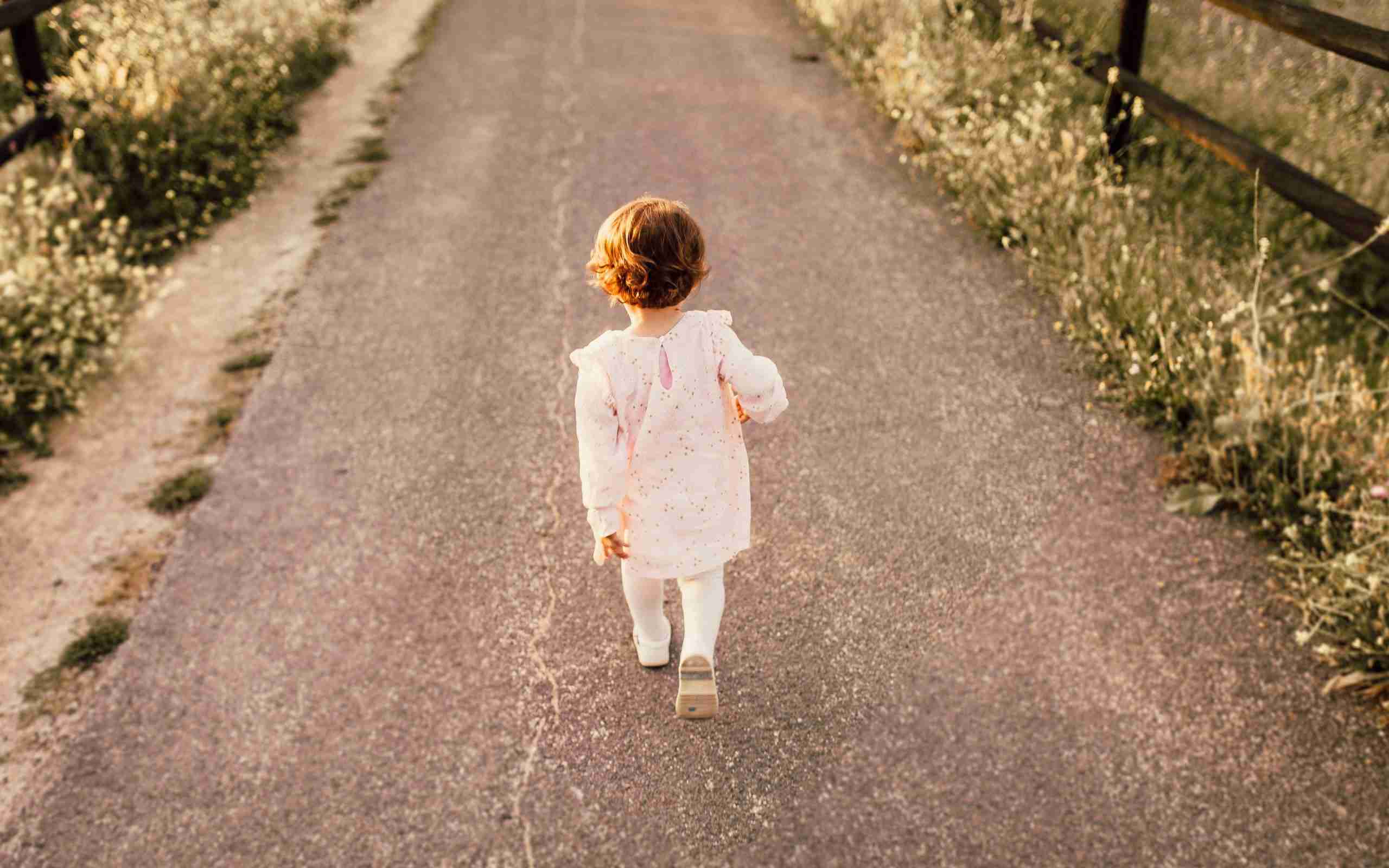 girl-wearing-white-clothes-walking-on-pavement-road-