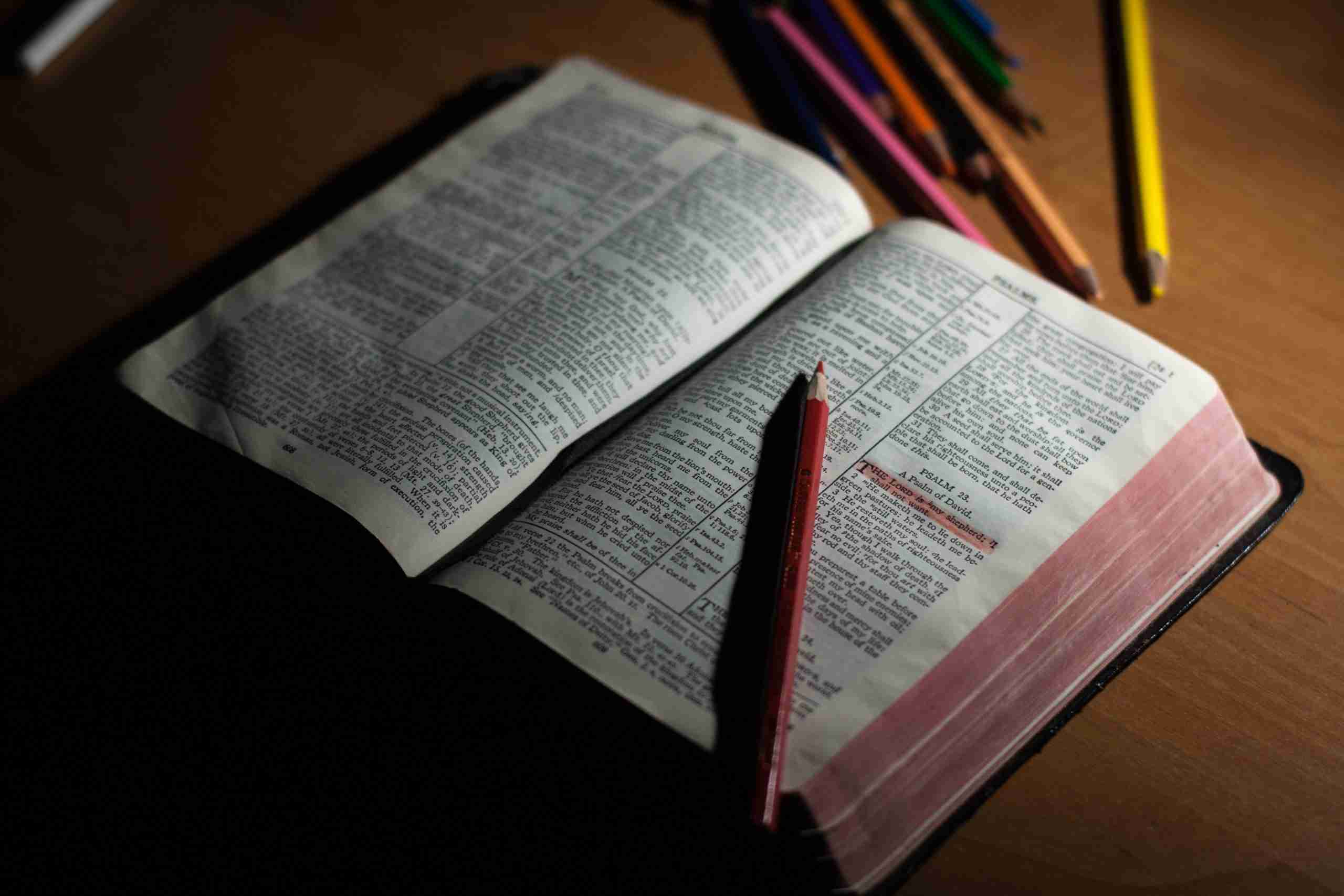 pink-pencil-on-open-bible-page-and-pink