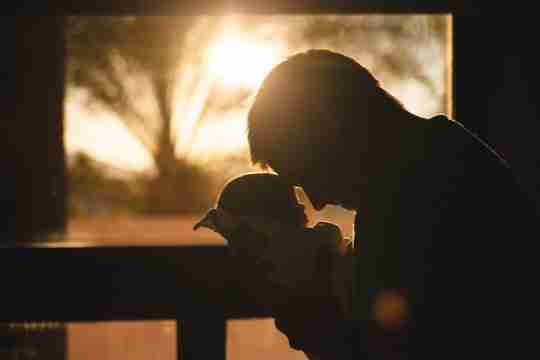 man-carrying-baby-drawing-their-foreheads