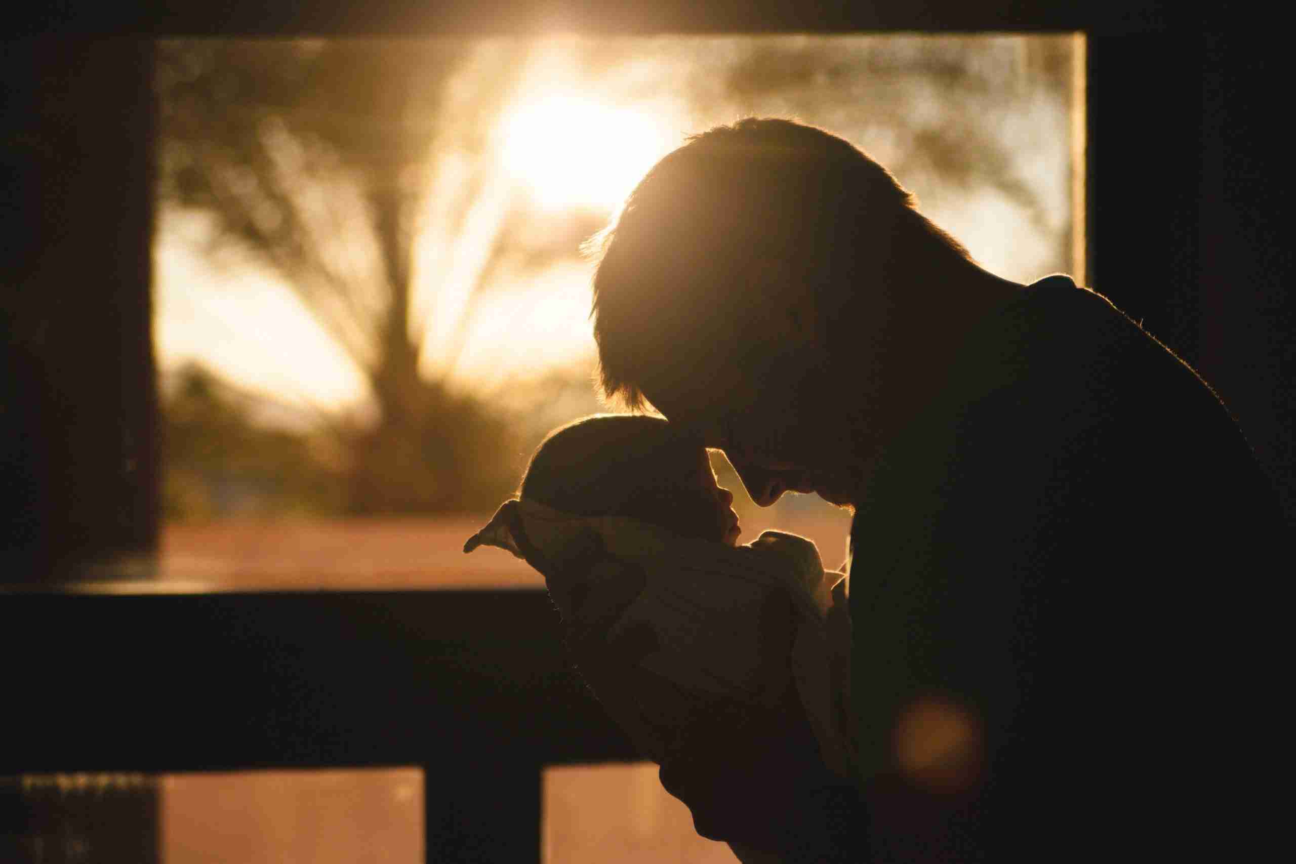 man-carrying-baby-drawing-their-foreheads