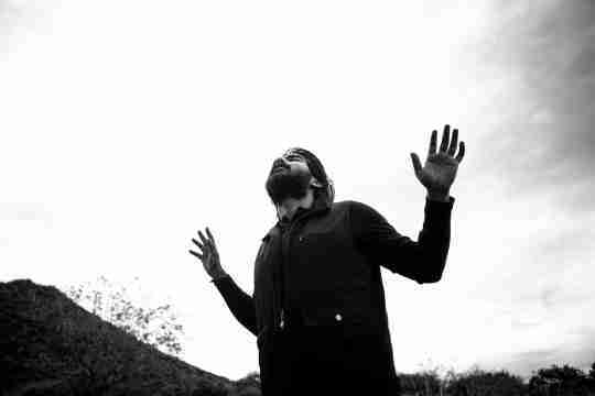 man-raising-his-hands-while-praying