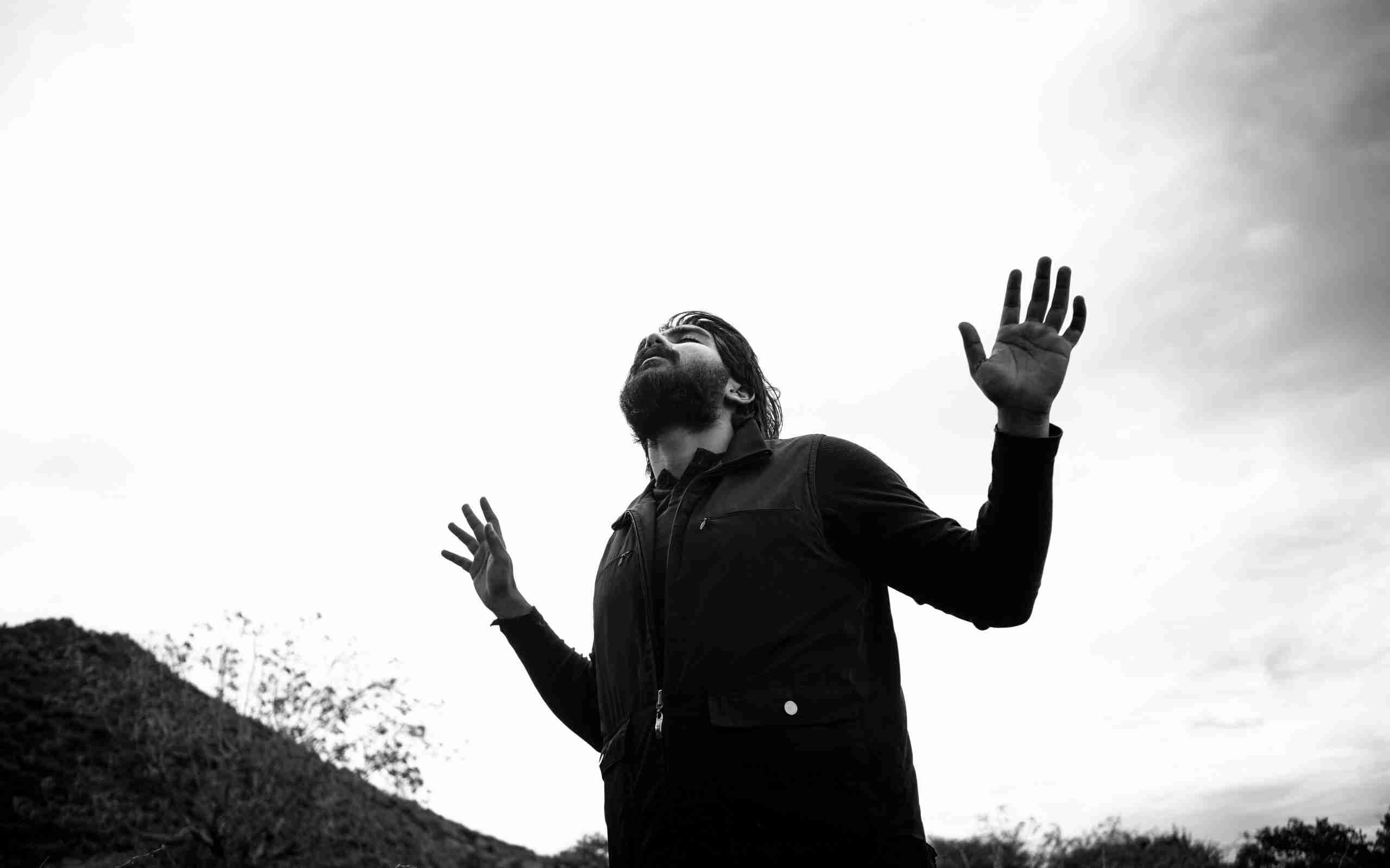 man-raising-his-hands-while-praying